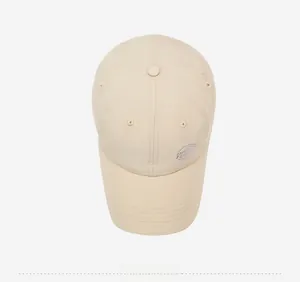 Detailed top-down view of a breathable beige baseball cap with purple embroidered logo