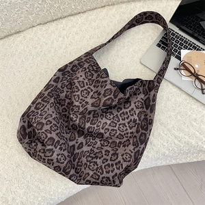 Leopard print tote bag displayed on a soft white rug with aesthetic lifestyle props