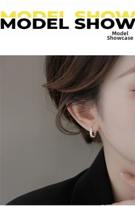 Detail view of s925 sterling silver daisy hoop earrings on a model showing fine texture
