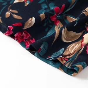 Close-up of floral print dress hem with navy fabric and detailed double stitching