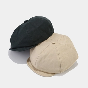 Retro twill newsboy caps in black and khaki shown on a minimalist neutral background