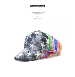 Detailed pile of tie-dye star pattern baseball caps in various colors on white background