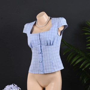 Detail of light blue plaid blouse with square collar and button down front design