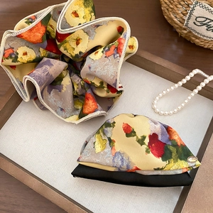 Detail of floral scrunchie set with retro oil painting patterns and gold LOVE pendant