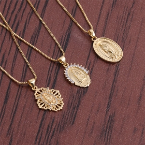 Detailed view of three gold Virgin Mary pendants with oval and crystal-encrusted designs