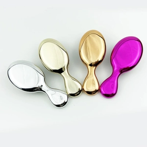 Detailed top view of portable mini air cushion hairbrushes in four metallic finishes