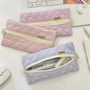 Detailed view of quilted cotton pencil cases in pastel colors with high-quality zipper