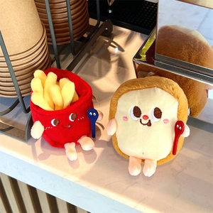 Close-up of creative plush fries and toast keychain charms with cute embroidered faces