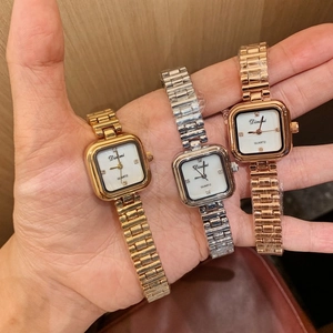 Close-up of square quartz watches with shell faces and crystal markers in three metal colors