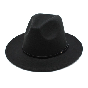 Close-up of black wool fedora featuring a slim leather band and golden metal stud detail