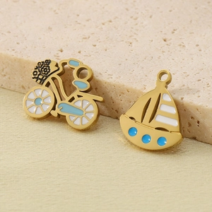 Gold stainless steel pendants featuring a blue enamel bicycle and a white sailing boat charm