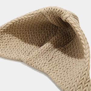 Detail shot of beige quilted fabric with herringbone pattern and interior lining