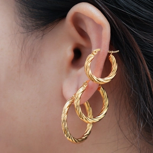 Three sizes of gold twisted hoop earrings set for women in minimalist retro style