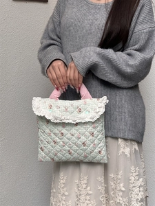 Quilted green cartoon rabbit laptop sleeve with pink handles and delicate lace trim