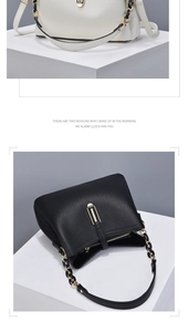 Detailed view of leather bucket bags in black and beige with elegant gold chain straps