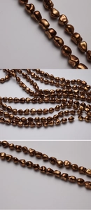 Close-up of irregular baroque pearls with metallic brown luster and antique bronze finish
