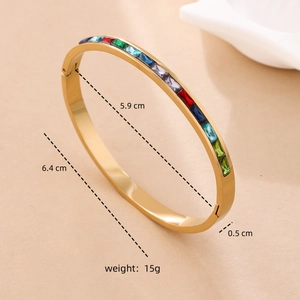 Detailed view of gold titanium steel bracelet showing 5.9cm inner diameter and colorful gems