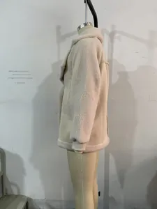Side view of oversized beige faux shearling jacket with large lapel and ribbed cuffs