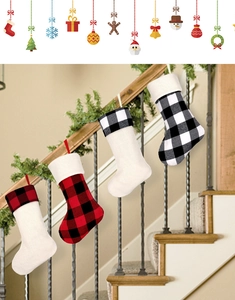 Close-up of four red and black buffalo plaid Christmas stockings hanging on a staircase