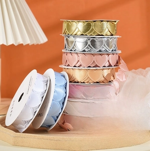 Close-up of heart-shaped hollowed decorative ribbons in metallic and Morandi colors