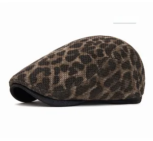 Detailed texture of light khaki leopard print newsboy cap in warm knitted fabric
