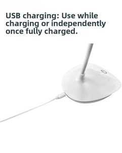 Detail showing white lamp base with touch power button and USB charging cable connectivity