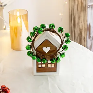 Christmas wreath with green metallic bells on a cozy holiday tabletop setting