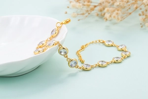 Close-up of golden star geometric bracelet with zircon crystals and lobster clasp closure