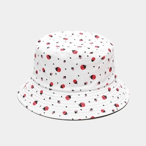 Detail shot of white cotton bucket hat with ladybug and heart print patterns