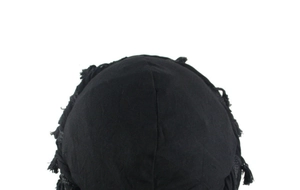 Macro shot of black satin-lined beanie featuring woven texture and fringe detailing