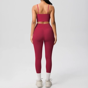 Detail view of the back of a deep red yoga set featuring thin strap top and high waist leggings