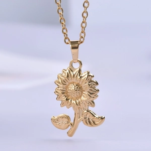 Detailed view of a golden sunflower pendant necklace with intricate petal textures