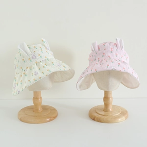 Detail of baby sun hats with 3D bunny ears, tulip prints and breathable bubble cotton texture