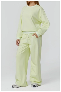 Detail of light yellow sweatshirt set with white striped cuffs and elastic wide-leg pants