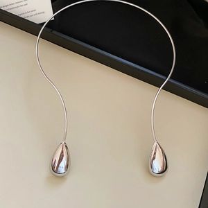 Polished silver teardrop torque necklace featuring minimalist sleek metallic design