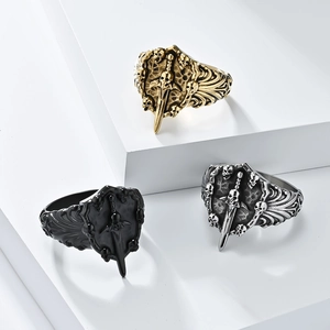 Gothic skull and sword rings in gold, silver, and black finish on geometric blocks