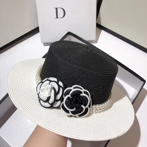 Elegant wide brim straw hat with decorative camellia flowers and pearl ribbon detail