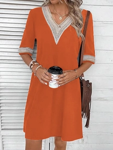 Orange V-neck dress with white lace trim and short sleeves in a loose casual style