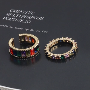Detail of colorful cubic zirconia adjustable rings with gold-plated bead edges