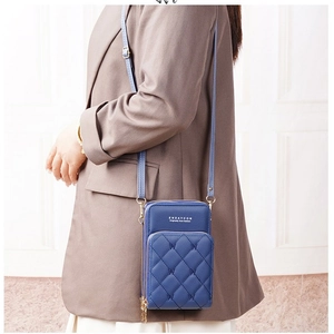 Navy blue quilted PU leather mobile phone crossbody bag shown on model with shoulder strap