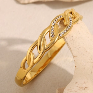 Close-up of 18K gold plated interlocking chain bracelet with zircon stones on stone base