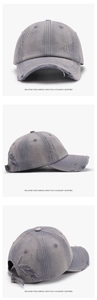 Detail of washed grey baseball cap with distressed rip effects and adjustable metal buckle