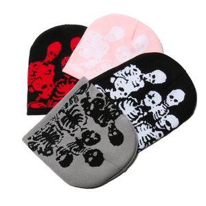 Knit skull beanie hats in black, pink, and grey colors with skeleton pattern jacquard