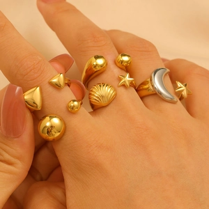 Chic gold and silver celestial ring set featuring star moon and shell designs on model