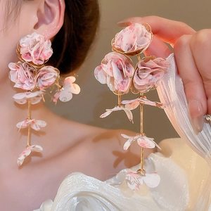 Detail of pink chiffon fabric rose earrings with long gold tassel and floral petal charms