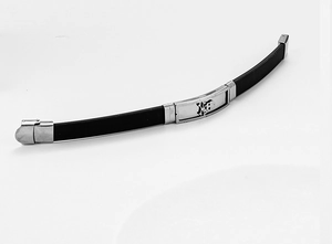Detail of black silicone bracelet featuring a hollow skull crossbones steel plate