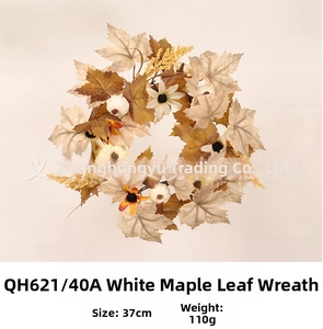 Detailed view of white maple leaf wreath with mini pumpkins and autumn berries decoration