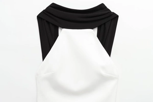 Close-up of black and white contrast neckline design on a patchwork mini dress