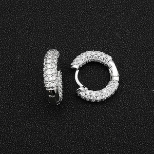 Macro shot of silver-toned hoop earrings encrusted with clear cubic zirconia pavé setting