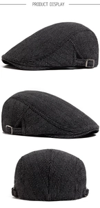 Detail view of herringbone tweed flat cap showing adjustable side metal buckle